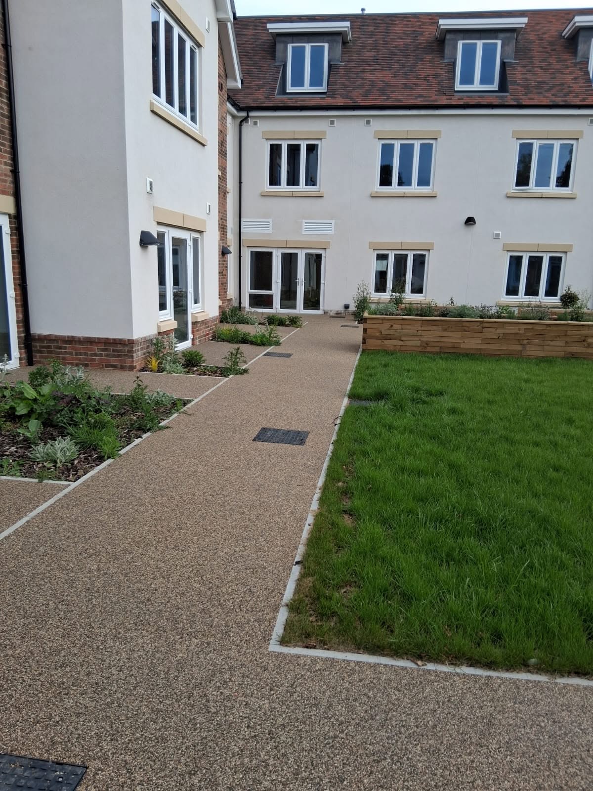 Resin path with edging running beside a new lawn