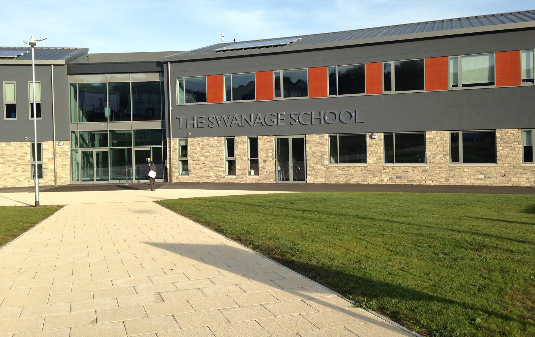 Paved approach path and lawn leading to the entrance of The Swanage School