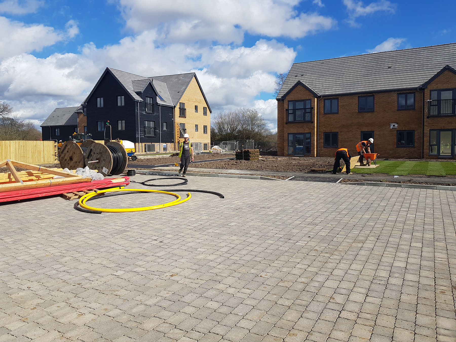 McNamara operatives laying block paving with ducting ready on site at Warfield, Bracknell